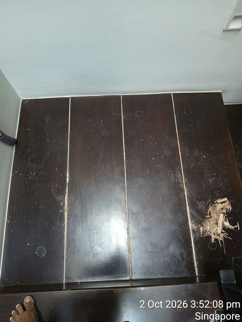 Splintered, broken dark timber stair board before repair