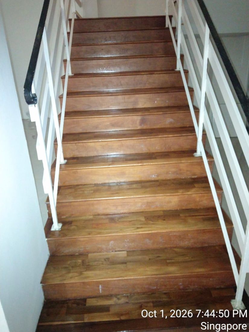 Varnished timber staircase with white railings
