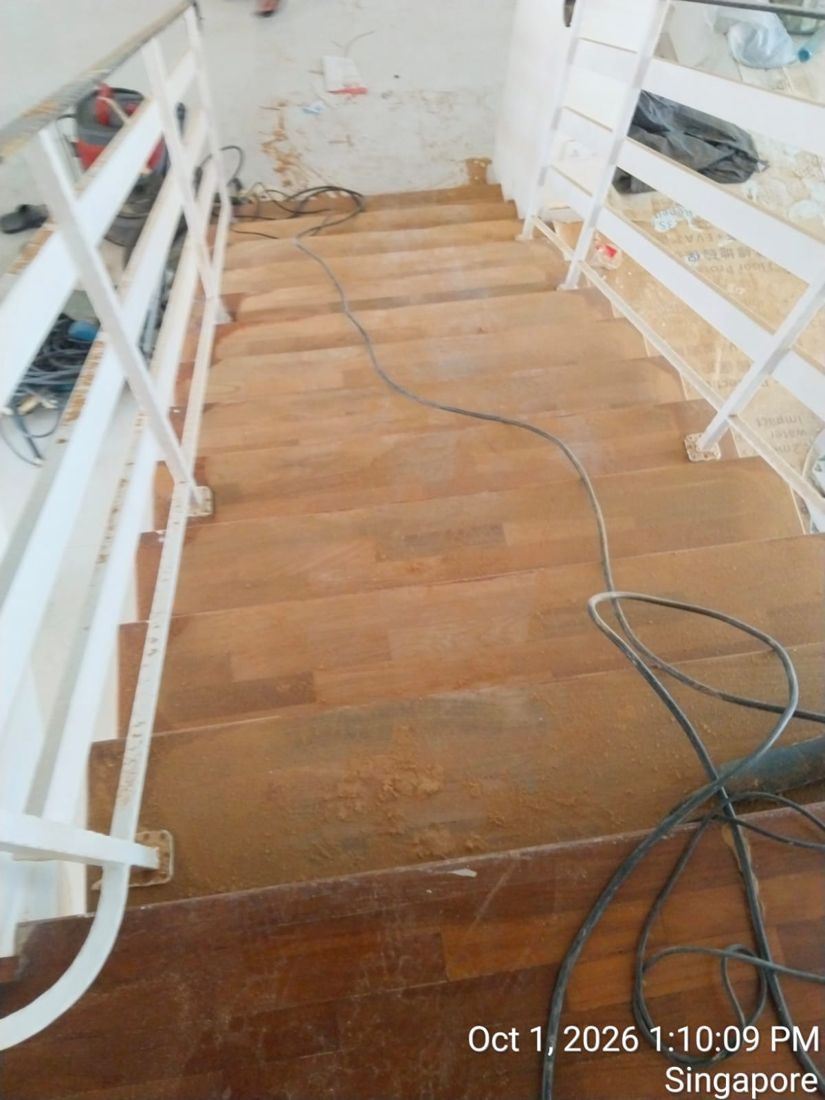 Timber staircase during sanding with the sander cable on the landing